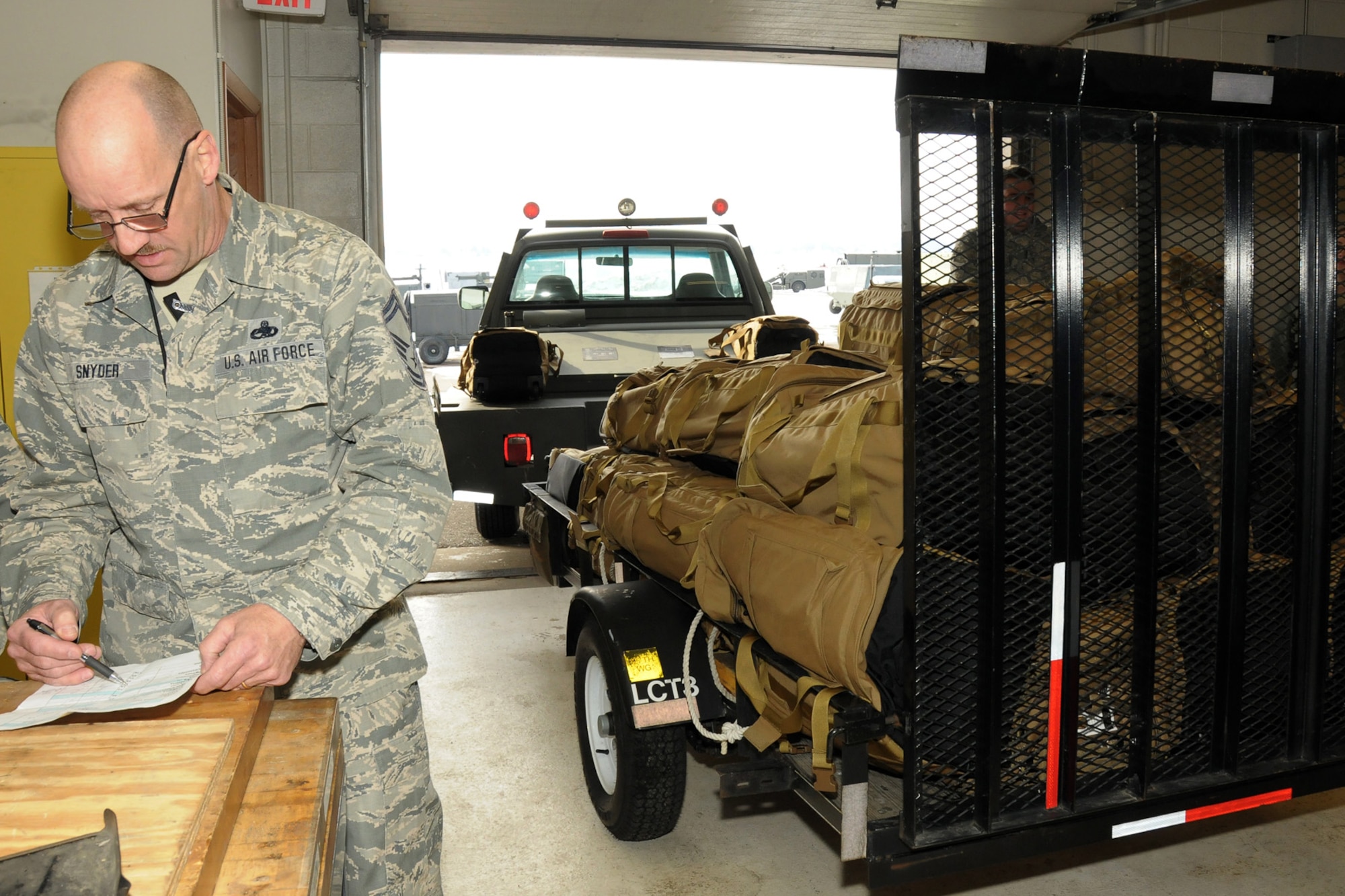 150308-Z-YW189-016 -- Senior Master Sgt. Charles checks a packing list during the process of preparing some 350 “mo-bags” – or mobility bags -- for Airmen of the 127th Wing who recently deployed to Southwest Asia. The deployment involved a total team effort around the wing. (U.S. Air National Guard photo by Staff Sgt. Samara Taylor)