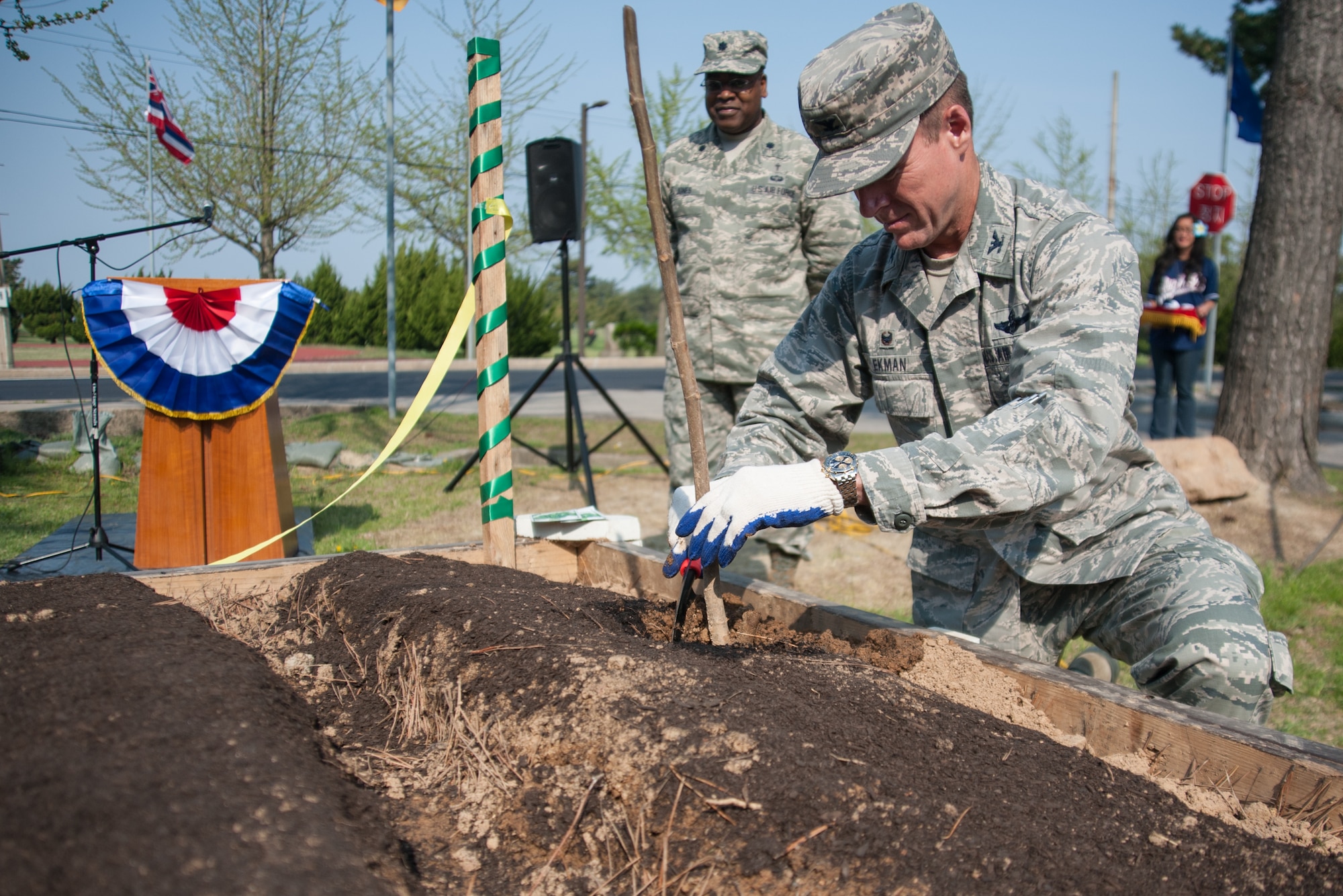 Col. Ken “Wolf” Ekman, 8th Fighter Wing commander, plants a fig tree in the Wolf Pack Garden in observance of Earth Day at Kunsan Air Base, Republic of Korea, April 22, 2015. The garden project started March 14 as part of a community initiative to promote healthy living for Wolf Pack Airmen. (U.S. Air Force photo by Tech. Sgt. George Maddon/Released)