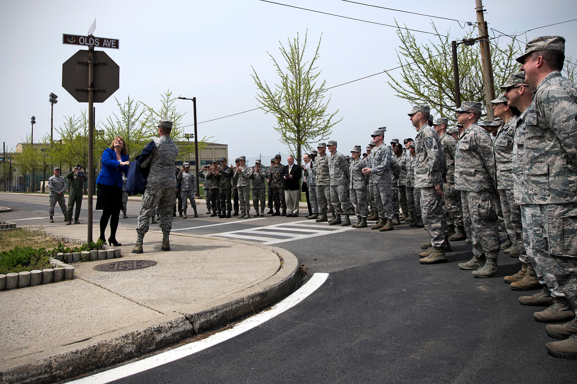 Christina Olds, daughter of Brig. Gen. Robin Olds, and Col. Ken “Wolf” Ekman, 8th Fighter Wing commander, unveil the new title of Kunsan’s main road – Olds Avenue – during a memorialization ceremony April 23, 2015, at Kunsan Air Base, Republic of Korea. In honor of the 8th FW’s heritage, additional road signs can now be seen across the Wolf Pack to include: Bolo Avenue in honor of the 8th Tactical Fighter Squadron’s Operation Bolo, James Avenue in memory of Gen. Daniel James Jr., Walmsley Avenue in memory of Capt John S. Walmsley Jr., Phantom Court in honor of the F-4 aircraft, Sabre Avenue in honor of the F-86 aircraft, and Wolf Pack Way to commemorate Kunsan’s rich history.  (U.S. Air Force photo by Senior Airman Katrina Heikkinen/Released)