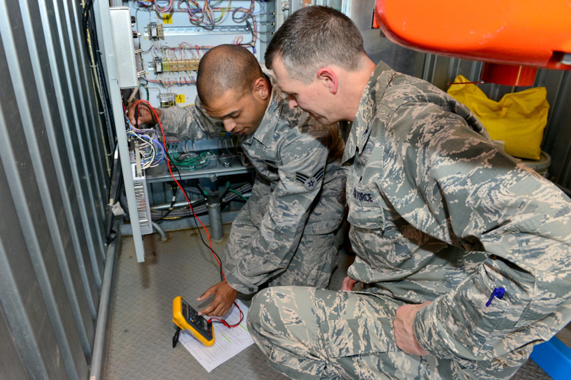Senior Airman Derek Miles, 39th Operations Support Squadron ground radar technician, teaches Col. Craig Wills, 39th Air Base Wing commander, the proper way to perform a power supply check on an antenna pedestal polarizer April 16, 2015, at Incirlik Air Base, Turkey. As part of the commander’s Out Connecting with Airmen Program, Wills travels to a different office or unit each week to better understand the jobs of Team Incirlik’s Airmen. (U.S. Air Force photo by Senior Airman Michael Battles/Released)