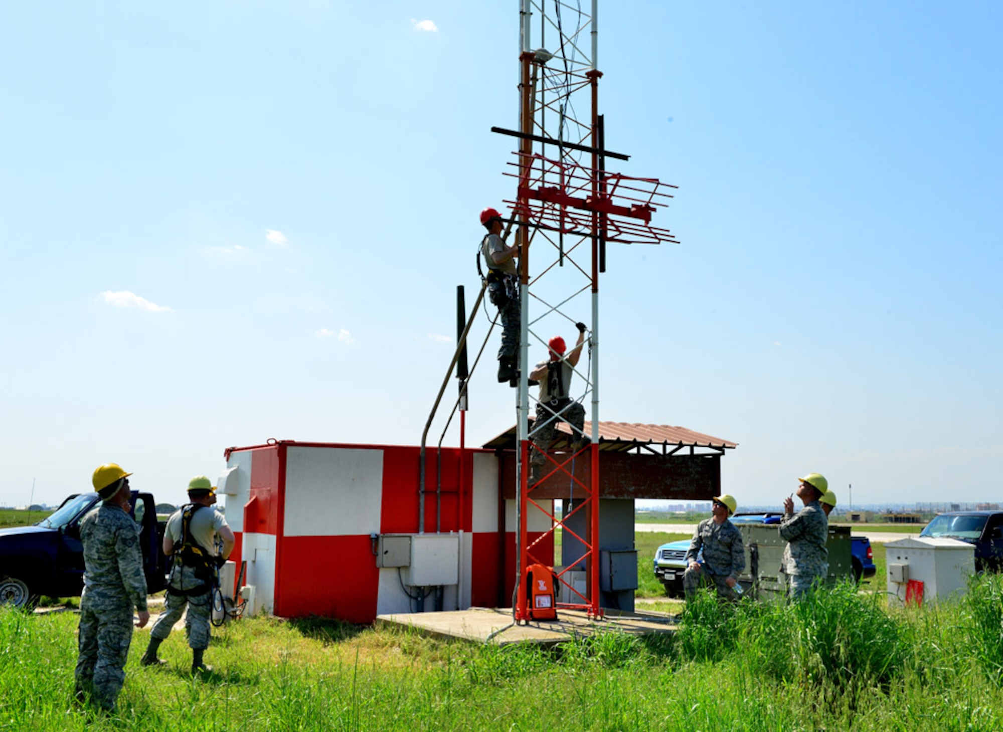 Col. Craig Wills, 39th Air Base Wing commander, and Airman 1st Class Matthew Coyle, 39th Operations Support Squadron air field systems technician, climb a glideslope tower to perform a light installation April 16, 2015, at Incirlik Air Base, Turkey.  Along with performing the light installation, Wills also performed a power supply check on an antenna pedestal polarizer as part of the commander’s Out Connecting with Airmen Program. (U.S. Air Force photo by Senior Airman Michael Battles/Released)