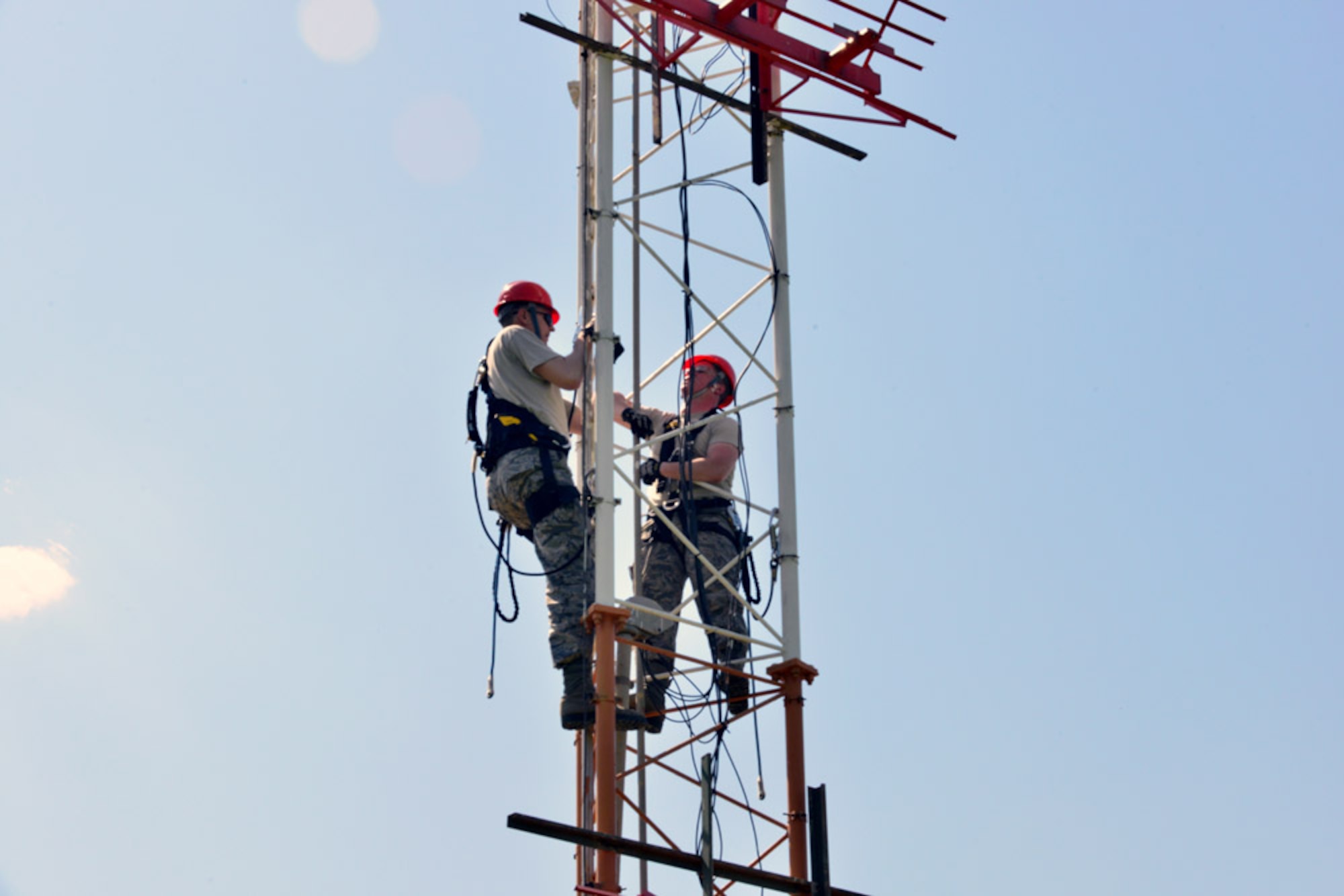 Col. Craig Wills, 39th Air Base Wing commander, and Airman 1st Class Matthew Coyle, 39th Operations Support Squadron air field systems technician, climb a glideslope tower to perform a light installation April 16, 2015, at Incirlik Air Base, Turkey.  Each week, Wills travels to units and offices across Team Incirlik as part of the commander’s Out Connecting with Airmen Program to better understand their jobs. (U.S. Air Force photo by Senior Airman Michael Battles/Released)