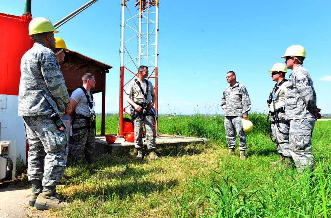 Col. Craig Wills, 39th Air Base Wing commander, speaks with members from the 39th Operations Support Squadron during a unit visit which is part of the commander’s Out Connecting with Airmen Program April 16, 2015, at Incirlik Air Base, Turkey. During his visit, Wills learned the proper way to perform a power supply check on an antenna pedestal polarizer and a light installation on a glideslope tower. (U.S. Air Force photo by Senior Airman Michael Battles/Released)