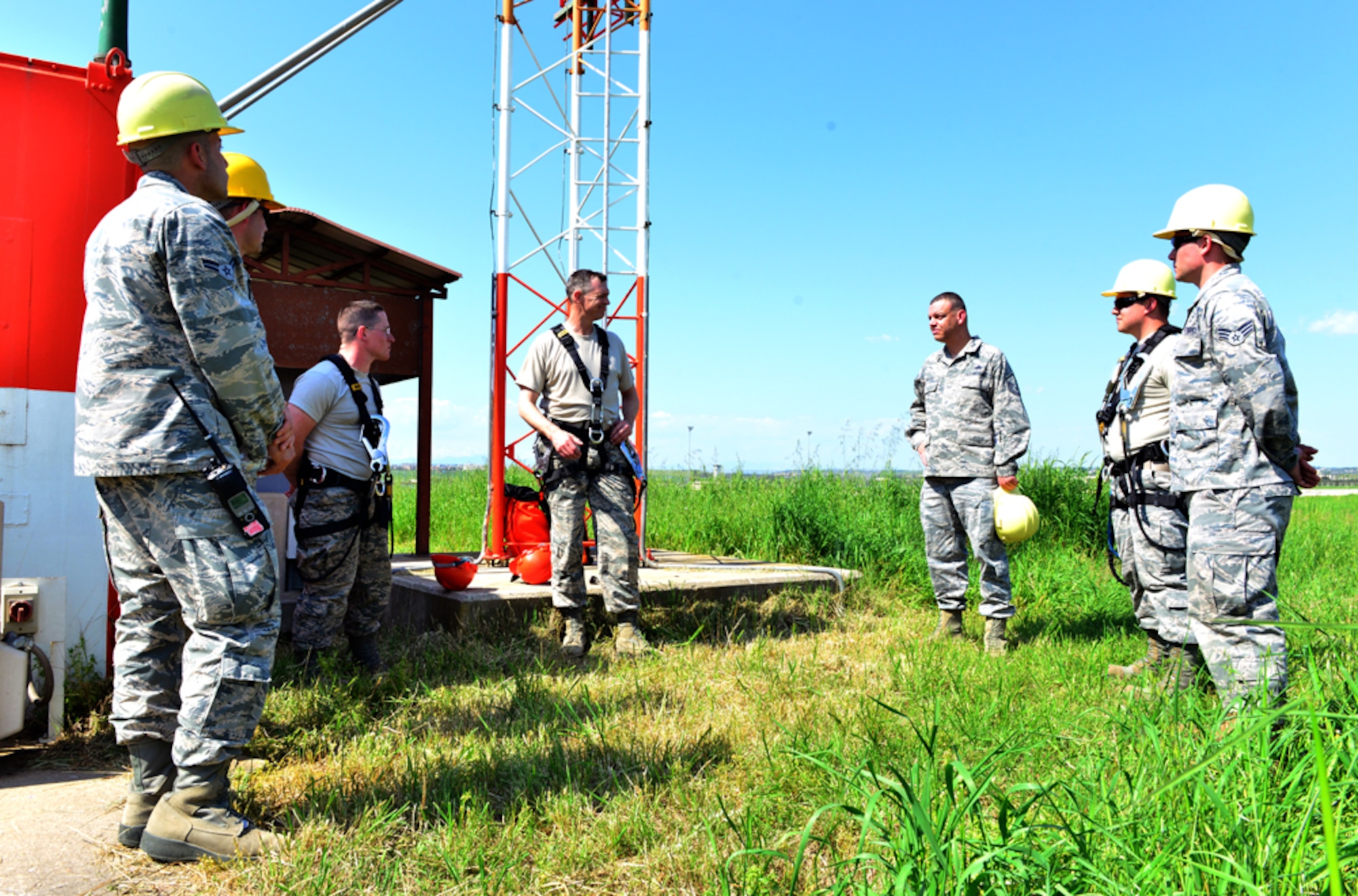 Col. Craig Wills, 39th Air Base Wing commander, speaks with members from the 39th Operations Support Squadron during a unit visit which is part of the commander’s Out Connecting with Airmen Program April 16, 2015, at Incirlik Air Base, Turkey. During his visit, Wills learned the proper way to perform a power supply check on an antenna pedestal polarizer and a light installation on a glideslope tower. (U.S. Air Force photo by Senior Airman Michael Battles/Released)