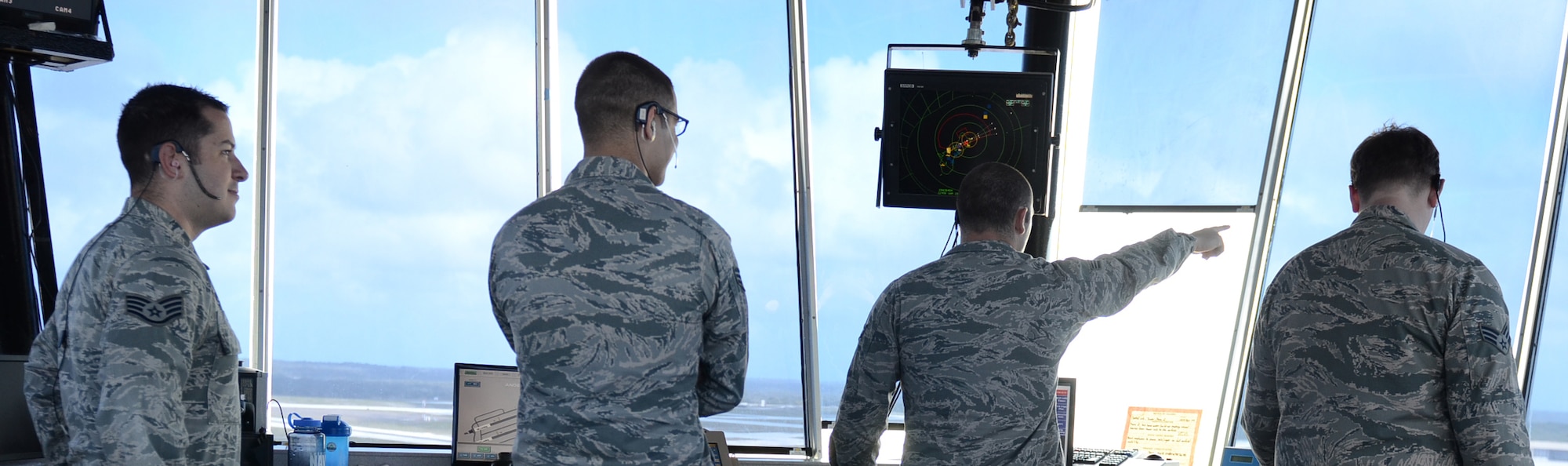 Air traffic control specialists from the 36th Operations Support Squadron survey for aircraft on the flightline at Andersen Air Force Base, Guam, April 21, 2015. Andersen air traffic controllers work with deployed aircraft and occasionally foreign aircraft to support Andersen’s mission on a daily basis. (U.S. Air Force photo by Airman 1st Class Alexa Ann Henderson/Released)