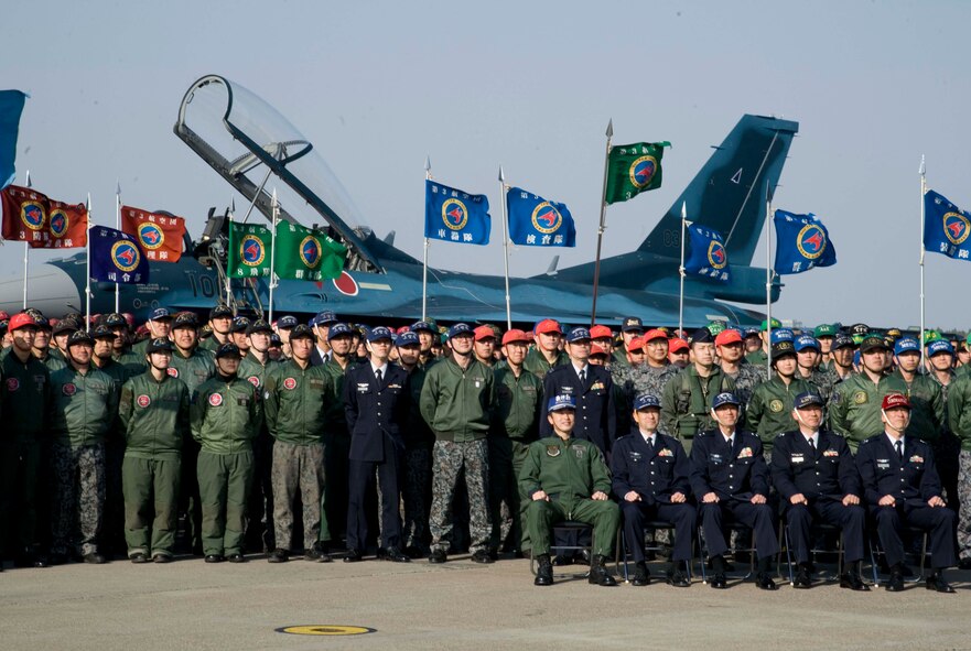 Members of the Japan Air Self-Defense Force gather in front of an F-2 Fighter aircraft for a picture at Misawa Air Base, Japan, April 22, 2015. The F-2 Fighter aircraft took its first flight from Komaki AB, Japan, to Misawa Air Base after being damaged at Matsushima Air Base, Japan, during the Great East Japan Earthquake and Tsunami in 2011. Because Matsushima is still undergoing the recovery process, six of the restored aircraft will be deployed to Misawa for pilot training. (U.S. Air Force photo by Airman 1st Class Jordyn Fetter/Released)