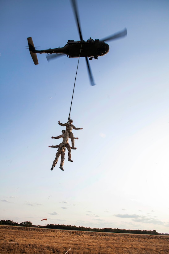 Airmen are lifted up by a UH-60 Black Hawk helicopter to a fast-rope insertion and extraction system during extraction training on Joint Base McGuire-Dix-Lakehurst, N.J., April 21, 2015. 