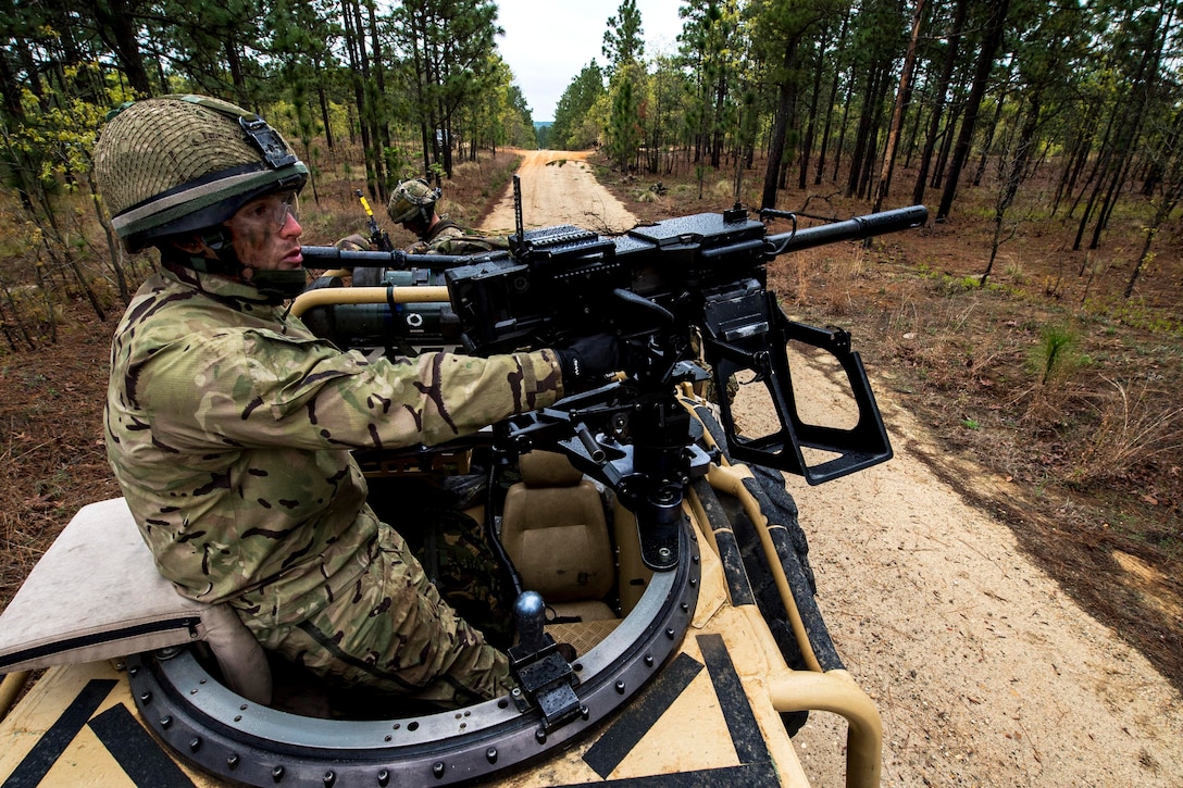 British Army Pvt. James Duncan mans the gunner's position of a Jackal armored vehicle during Combined Joint Operational Access Exercise 15-01 at Fort Bragg, N.C., April 15, 2015. Duncan is an antitank infantryman assigned to the 16th Air Assault Brigade