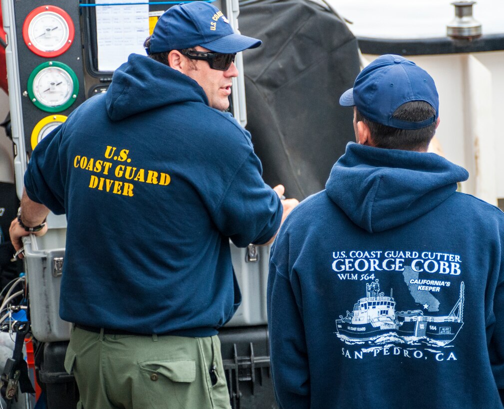 A Coast Guard diver relays vital oxygen and depth readings to the dive supervisor on the Coast Guard cutter George Cobb during dive training in the waters off the coast of San Pedro, Calif., April 22, 2015.