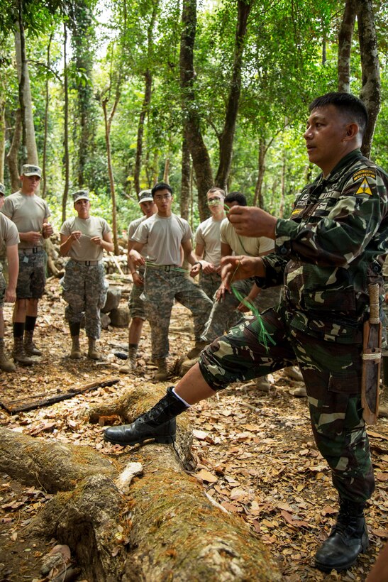 Filipino soldiers show U.S. soldiers how to make their own rope during a jungle training exercise in Fort Magsaysay, Philippines, April 17, 2015. 