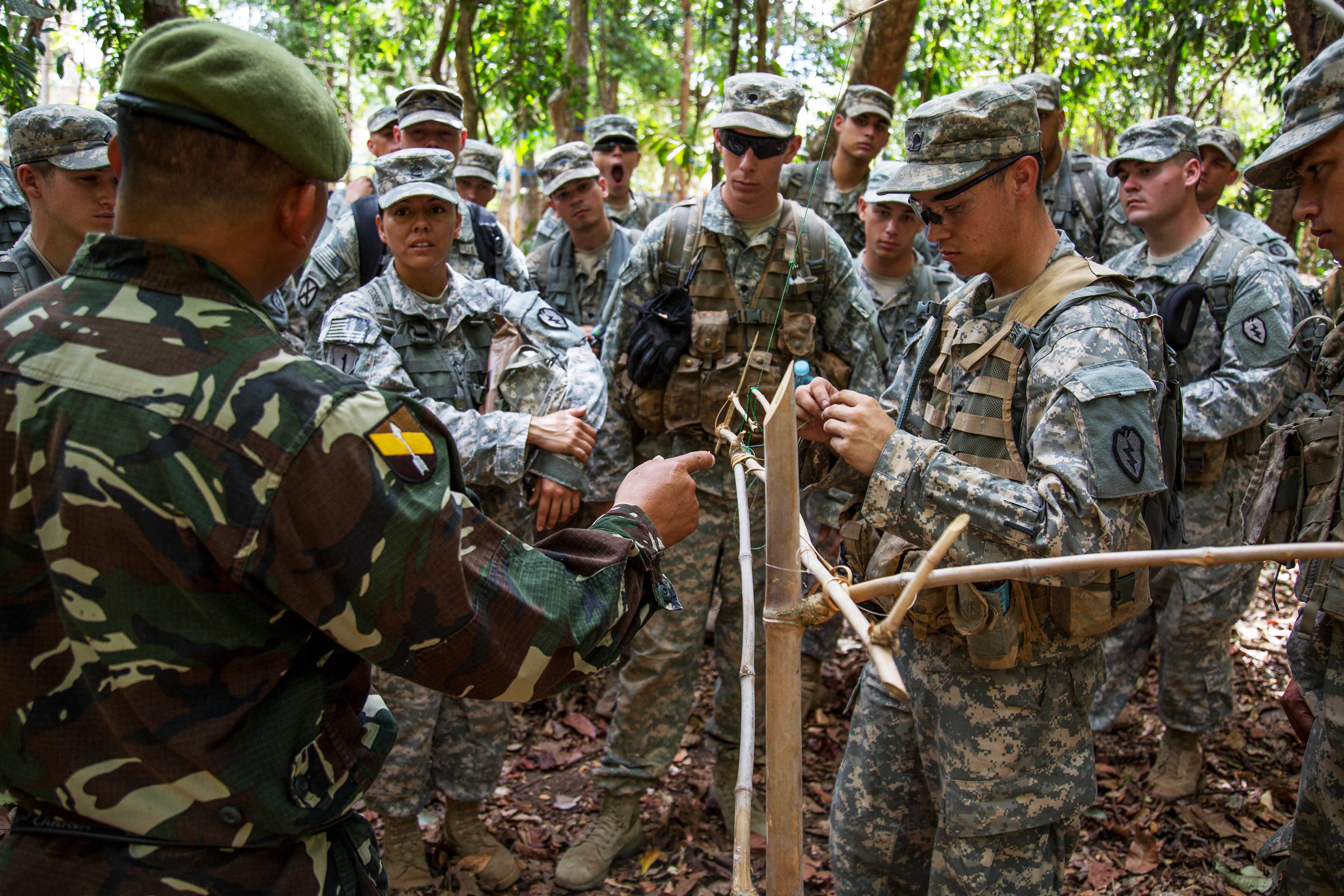 U.S. soldiers take part in a trapbuilding demonstration led by