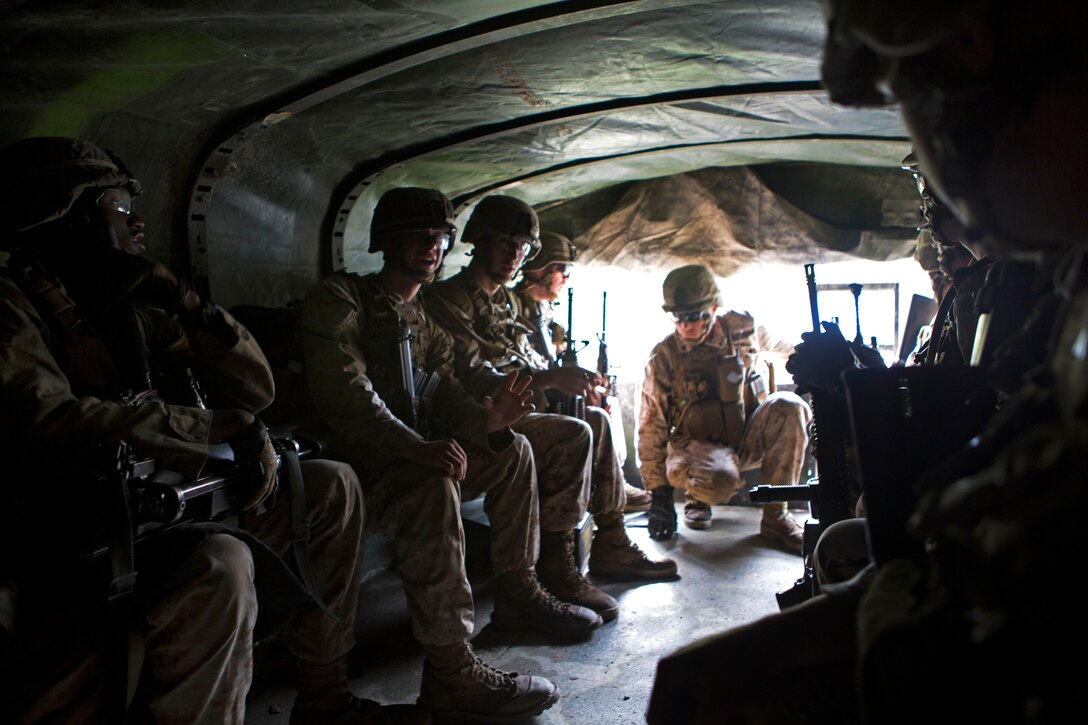 Marines sit in the back of a 7-ton truck before being transported to a live-fire range on 
Fort Pickett, Va., April 15, 2015.