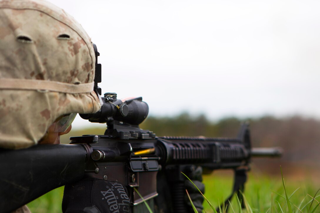 A Marine provides cover fire with an M16A4 rifle during an infantry platoon battle course on Fort Pickett, Va., April 15, 2015.