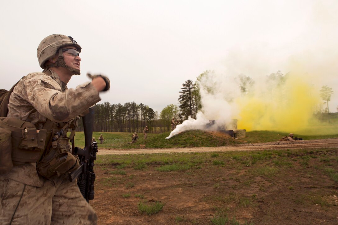 Marine Corps Lance Cpl. Michael R. Albright signals Marines to move forward during an infantry platoon battle course on Fort Pickett, Va., April 15, 2015. Albright is a team leader assigned to Fox Company, Battalion Landing Team, 26th Marine Expeditionary Unit.