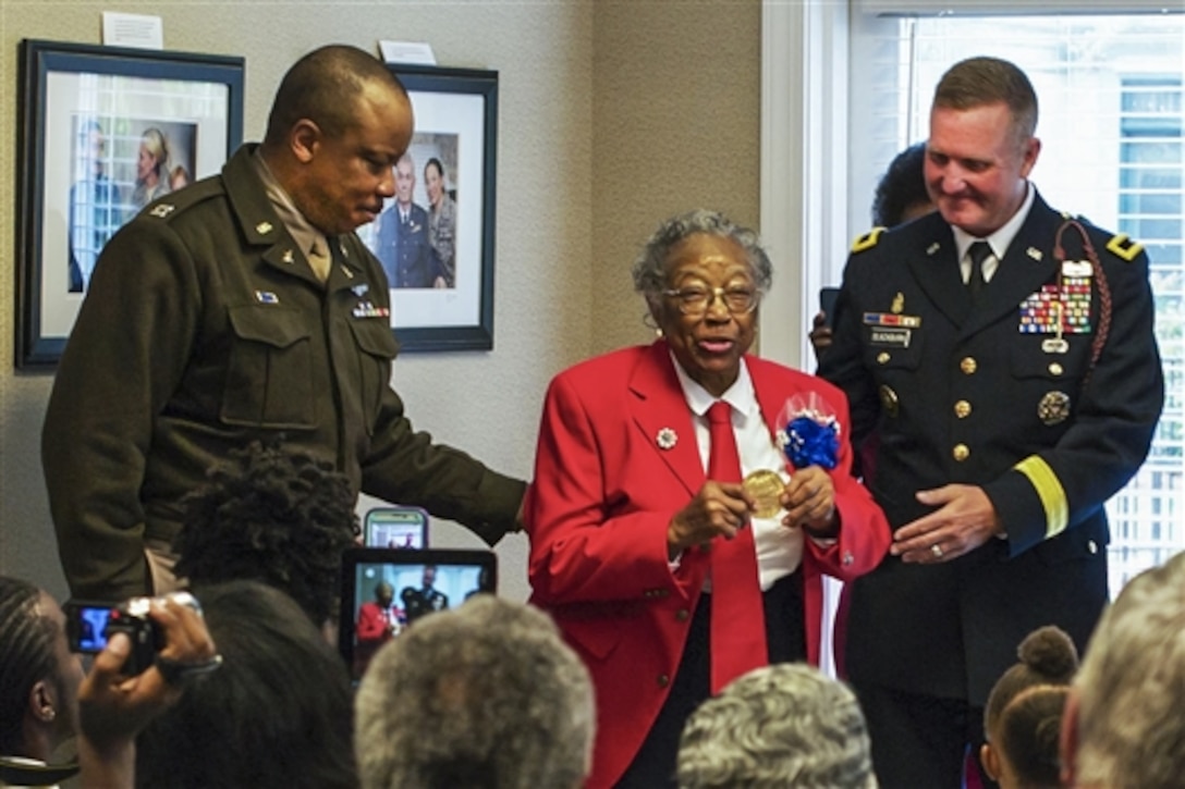 Army Air Corps Sgt. Amelia Jones, a veteran of the original Tuskegee Airmen, addresses the audience after receiving the Congressional Gold Medal at Hospice Savannah in Savannah, Ga., April 19, 2015. Attendees witnessed the 95-year-old veteran receive her medal, one of the two highest civilian awards in the United States. U.S. Sen. Johnny Isakson of Georgia (not pictured), Army Brig. Gen. James R. Blackburn Jr., right, and Army Command Sgt. Maj. Stanley Varner (not pictured) presented the medal. 
