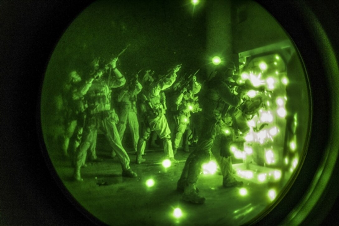 As seen through a night-vision device, Marines breach a door during visit, board, search and seizure training on Joint Base Langley-Eustis, Va., April 17, 2015. The Marines are assigned to Maritime Raid Force, 26th Marine Expeditionary Unit.
