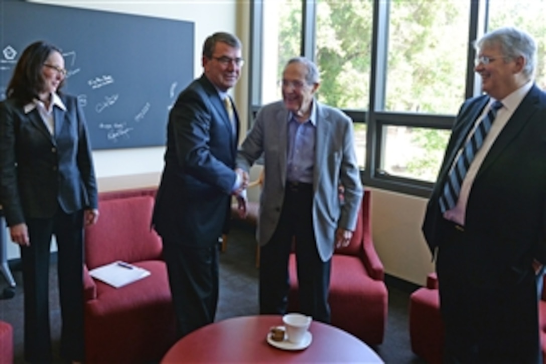 Defense Secretary Ash Carter, left, the nation's 25th secretary of defense, shakes hands with former Defense Secretary William J. Perry before delivering a lecture at the Stanford University Cemex Auditorium in Stanford, Calif., April 23, 2015. Perry served as the country's 19th defense secretary from Feb. 3, 1994 to Jan. 23, 1997. 