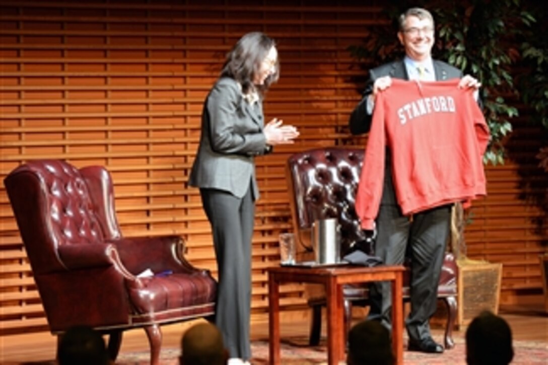Defense Secretary Ash Carter receives a Stanford sweater at the Drell Lecture at Stanford University, April 23, 2015. Carter delivered a lecture at Stanford, where he unveiled the Defense Department's new cyber strategy.