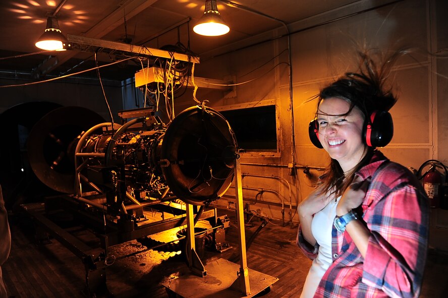 Ashley Kosturock, Mississippi State University student, experiences being up close to a T-38 Talon engine at full afterburner while in an engine test cell April 22, 2015 on Columbus Air Force Base, Mississippi. The students are aerospace engineering majors on a base tour. (U.S. Air Force photo by Airman Daniel Lile)