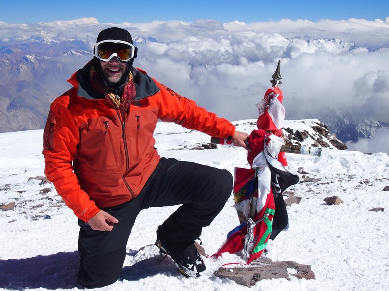 Lt. Col. Daniel Loveless, the 71st Medical Operations Squadron commander, kneels atop Aconcagua, Argentina, the highest point in the Southern and Western Hemispheres at 22,841 feet, in February. Loveless was one of 10 people in his group to crest the summit. His trek lasted from Feb. 7 to 21. (Courtesy photo)