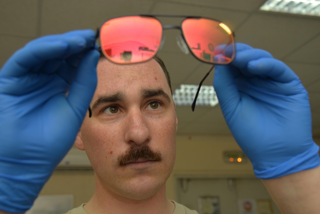 Staff Sgt. Scott ensures a pair of aircrew laser eye protection (ALEP) glasses is free from scratches and holds a tinted reflection at an undisclosed location in Southwest Asia April 15, 2015. ALEP’s protect eyesight from high intensity lasers which are not visible to the naked eye. Scott is an aircrew flight equipment technician assigned to the Expeditionary Operations Support Squadron. (U.S. Air Force photo/Tech. Sgt. Christopher Boitz)