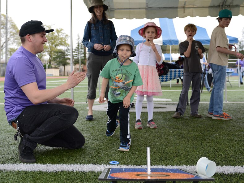 Children play a ring toss game April 19, 2015, at Yokota Air Base, Japan. Carnival style games, information booths and track races were available during the Youth Festival, which honored military children. (U.S. Air Force photo by Senior Airman Desiree Economides/Released)
