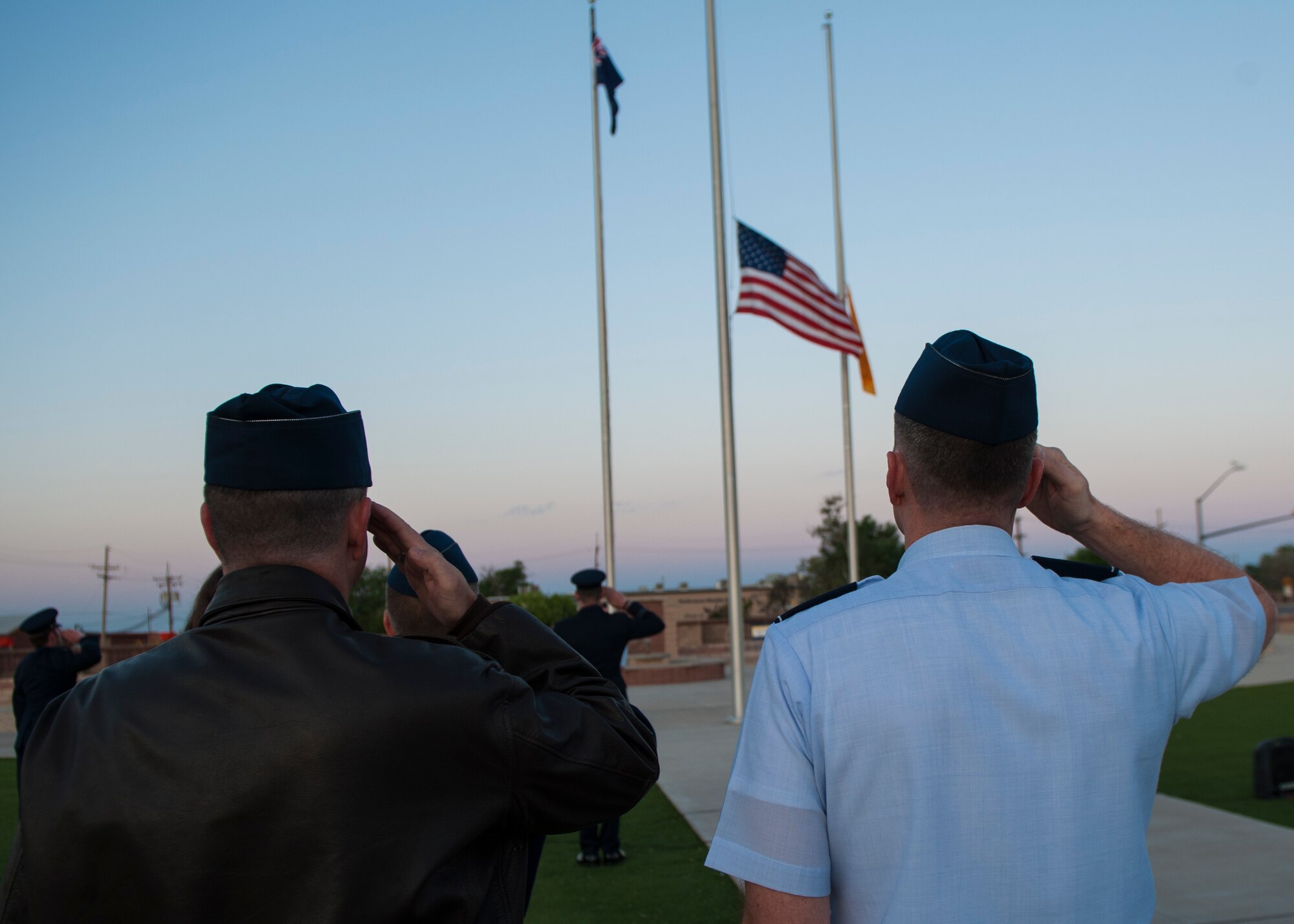 Members of the U.S. Air Force salute as the Australian flag is raised during the Anzac commemorative service at April 25, 2015 at Holloman Air Force Base, N.M. Holloman is home to five members of the Royal Australian Air Force. At dawn April 25, Australians around the world gather to honor those who made the ultimate sacrifice during World War I. During the first major Australian conflict of WWI, the Battle of Gallipoli, more than 8,000 members of the Australian and New Zealand Army Corps were killed. (U.S. Air Force photo by Airman 1st Class Emily A. Kenney/Released) 