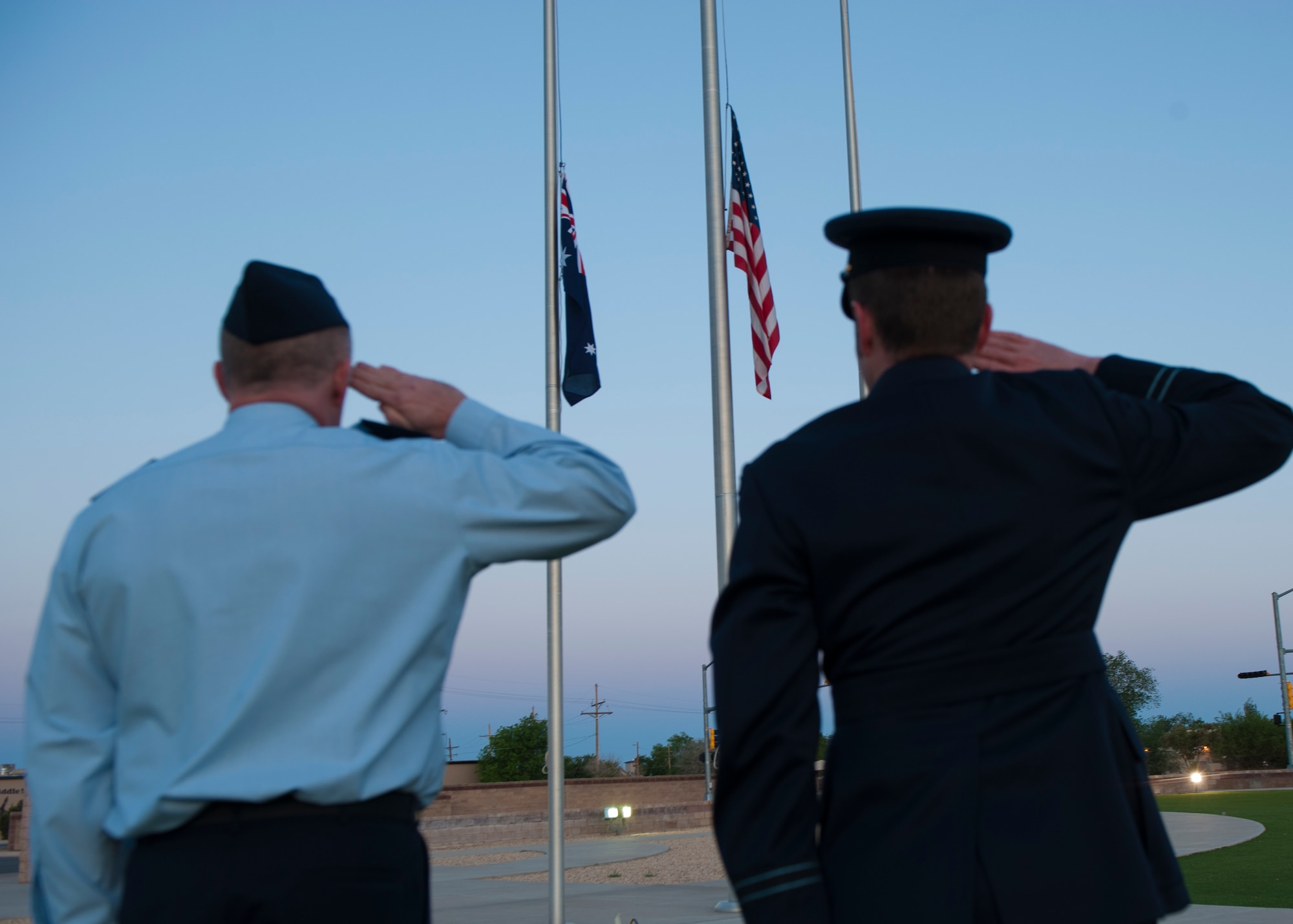 Members of the Royal Australian Air Force salute during Reveille at the Anzac commemorative service April 25, 2015 at Holloman Air Force Base, N.M. During the ceremony, attendants honor and remember the members of the Australian and New Zealand Army Corps [Anzac] who fought during World War I, specifically the battle at Gallipoli. Although that battle was a loss for the Anzac, Australians recognize the courage, mateship and honor of the 8,000 men who made the ultimate sacrifice. (U.S. Air Force photo by Airman 1st Class Emily A. Kenney/Released)  