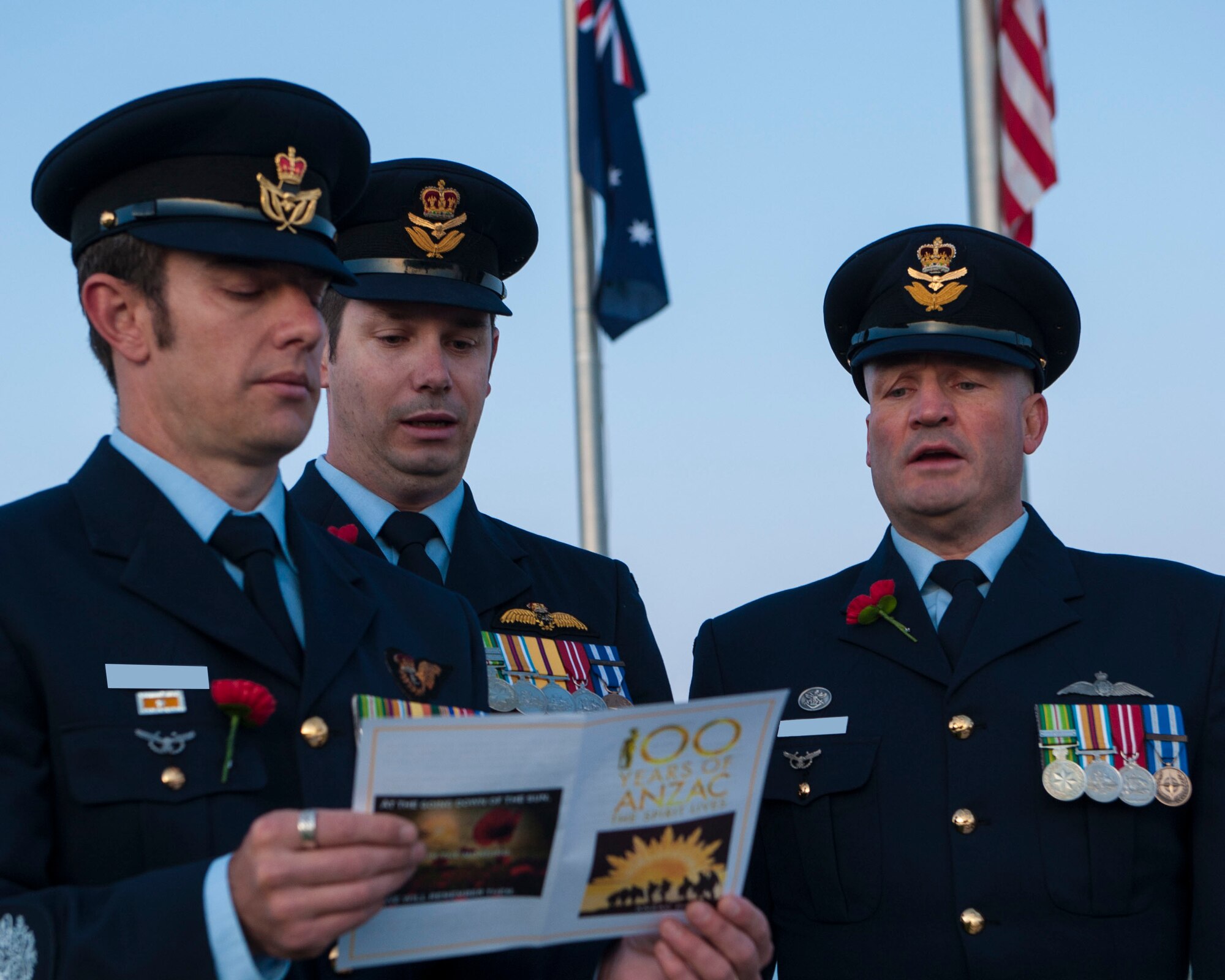 Members of the Royal Australian Air Force sing along to the hymn ‘Abide With Me’ during the Anzac Day commemorative service April 25, 2015 at Holloman Air Force Base, N.M. Australians around the world gather to reflect and recognize fallen members of the Australian and New Zealand Army Corps. Services are held at dawn, the original landing time at the battle of Gillipoli, to honor the more than 8,000 Anzac who died during that grueling 8-month battle. (U.S. Air Force photo by Airman 1st Class Emily A. Kenney/Released) 