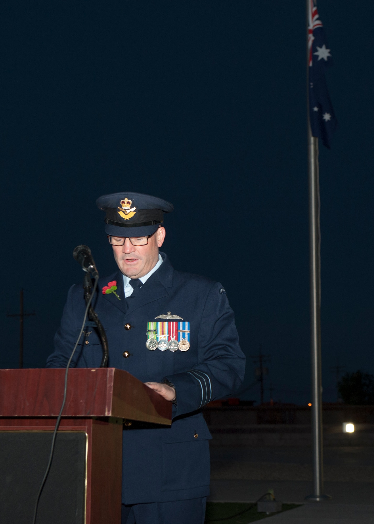 The Royal Australian Air Force’s senior military leader at Holloman Air Force Base speaks with Australian, American and German Airmen and civilians during the Anzac Day commemorative service, April 25, 2015 at Holloman AFB, N.M. Anzac, short for Australian and New Zealand Army Corps, refers to Australian or New Zealand military members who served in World War I. During World War II, Anzac Day became the day that Australians and New Zealanders remember the lives of all Australians lost in the war, and recognize the qualities of courage, mateship and sacrifice. (U.S. Air Force photo by Airman 1st Class Emily A. Kenney/Released)