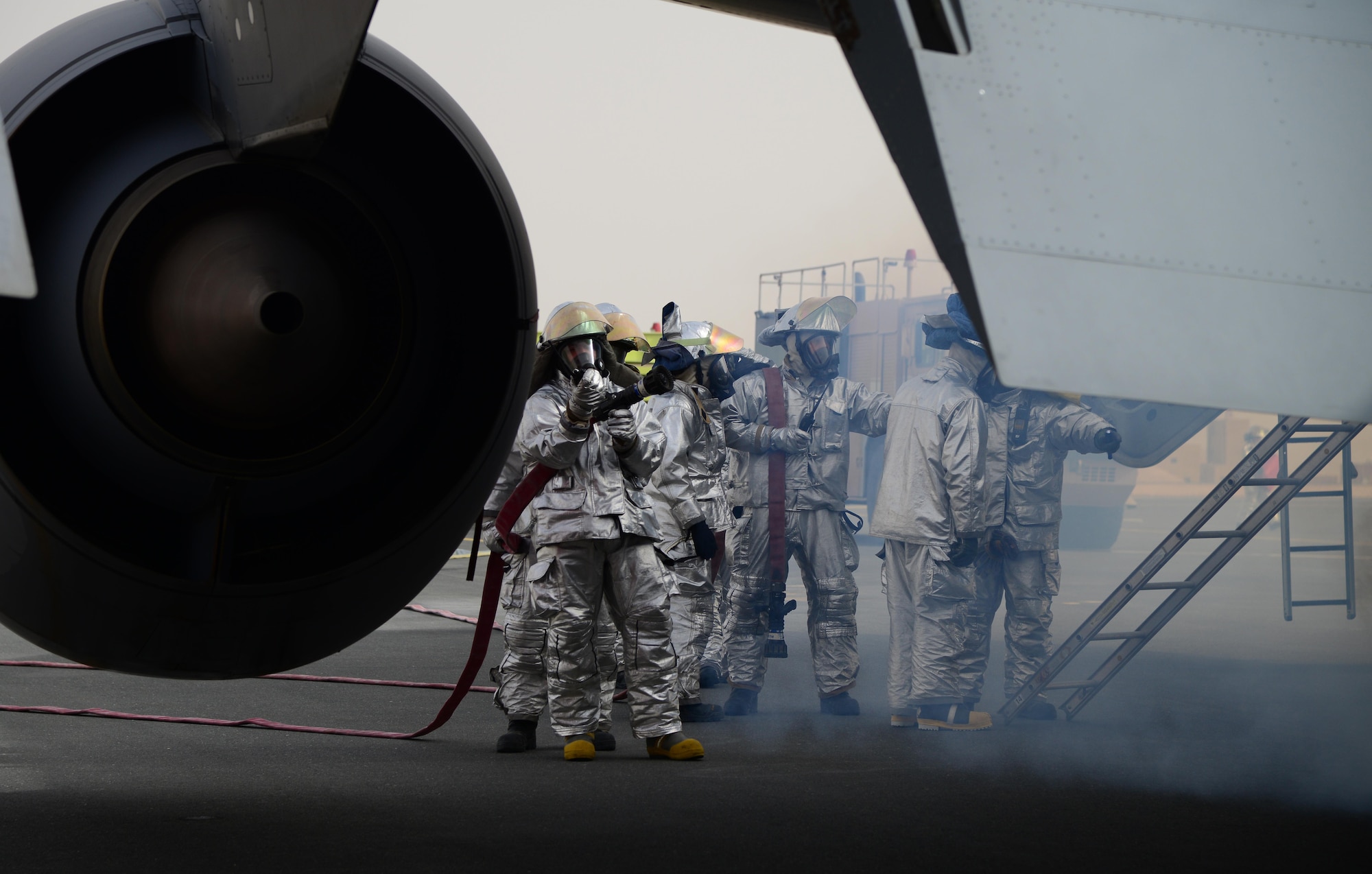 U.S. Air Force firefighters from the 379th Expeditionary Civil Engineer Squadron respond to a simulated aircraft accident during a Major Accident Response Exercise, April 22, 2015, at Al Udeid Air Base, Qatar. Firemen from the 379th Expeditionary Civil Engineer Squadron fire protection flight were the first on scene and were tasked with putting out a fire which started in the back of the aircraft. The MARE, which is a mission assurance exercise is required by all Department of Defense Bases on an annual cycle, ensures that personnel are properly trained and proficient at responding to incidents or threats in the event of a real world occurrence.  (U.S. Air Force photo by Senior Airman Kia Atkins)