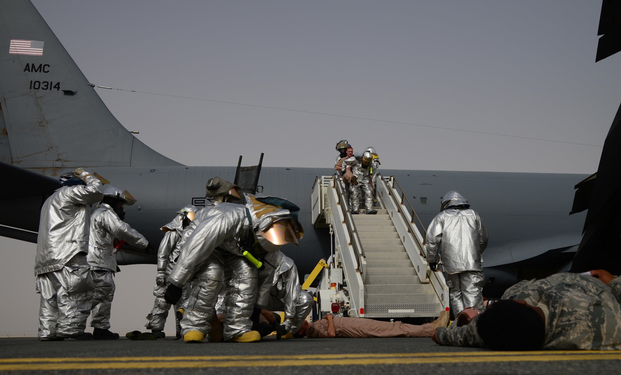 U.S. Air Force firefighters from the 379th Expeditionary Civil Engineer Squadron respond to a simulated aircraft accident during a Major Accident Response Exercise, April 22, 2015, at Al Udeid Air Base, Qatar. The MARE, which is a mission assurance exercise is required by all Department of Defense Bases on an annual cycle, ensures that personnel are properly trained and proficient at responding to incidents or threats in the event of a real world occurrence. (U.S. Air Force photo by Senior Airman Kia Atkins)