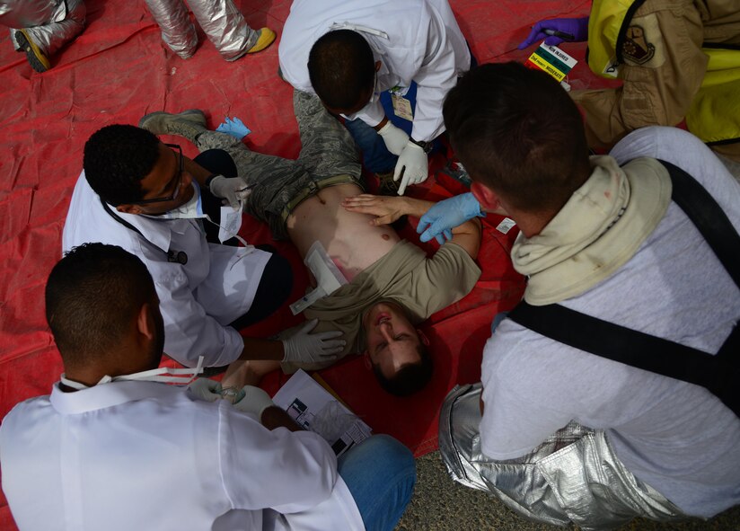 U.S. and Qatari first responders triage patients during a Major Accident Response Exercise, April 22, 2015, at Al Udeid Air Base, Qatar. The MARE showcased how host nation and U.S. military work together in an emergency response event. The MARE, which is a mission assurance exercise is required by all Department of Defense Bases on an annual cycle, ensures that personnel are properly trained and proficient at responding to incidents or threats in the event of a real world occurrence. (U.S. Air Force photo by Senior Airman Kia Atkins)