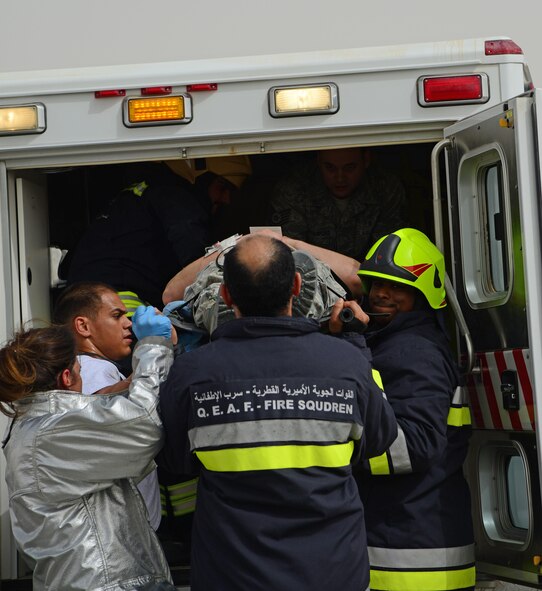 U.S. and Qatari first responders load a simulated victim into an ambulance during a Major Accident Response Exercise, April 22, 2015, at Al Udeid Air Base, Qatar. The MARE showcased how host nation and U.S. military work together in an emergency response event. The MARE, which is a mission assurance exercise is required by all Department of Defense Bases on an annual cycle, ensures that personnel are properly trained and proficient at responding to incidents or threats in the event of a real world occurrence. (U.S. Air Force photo by Senior Airman Kia Atkins)