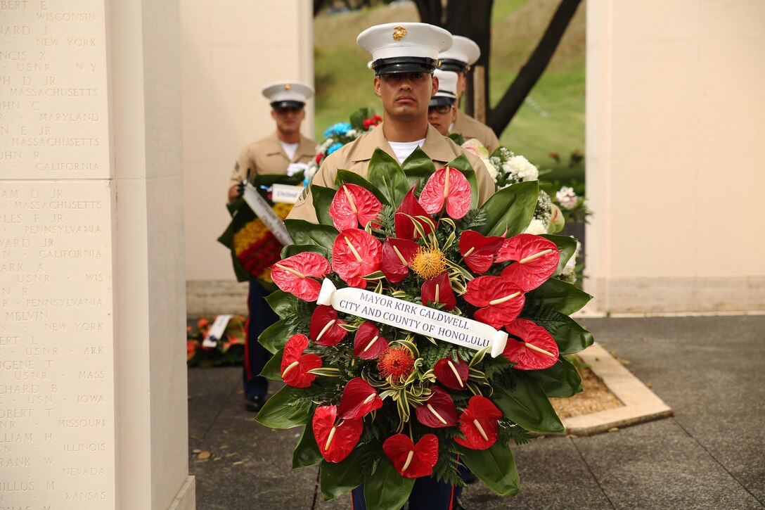 Sgt. Henry Cisneros, supply noncommissioned officer with U.S. Marine Corps Forces, Pacific, carries one of many wreaths presented during the ANZAC Day Ceremony April 25, 2015, at the National Memorial Cemetery of the Pacific. The day commemorated the 100th anniversary of the Gallipoli Campaign, fought by Australian-New Zealand Army Corps forces in World War I. The battle is remembered for the valiant men and the significant losses the nations both suffered. Those who fought are known as “ANZACS” and are honored in one of the most recognized holidays in the South Pacific.