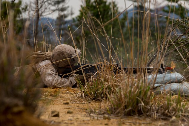 Lance Cpl. Jayson Coss, a Motor Transport operator with Marine Wing Support Squadron 171, Motor-T Company, fires an M240 bravo machine gun at a passing mounted patrol during a simulated attack at the Japan Ground Self-Defense Force’s Haramura training grounds during Exercise Haramura 1-15 in Hiroshima, Japan, April 14, 2015. Haramura is a weeklong company-level training exercise focused on honing the skills Marines learned during Marine Combat Training and their Military Occupational Specialty schooling.