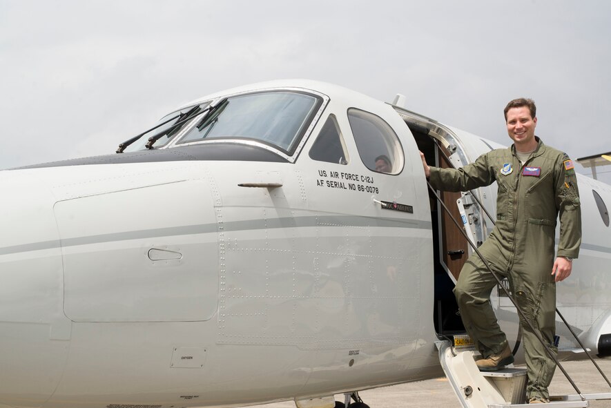 Capt. Thomas Powell, Chief of Current Operations for Yokota’s 459th Airlift Squadron and C-12J instructor pilot, stands at the door of a C-12J aircraft. Powell will head out to the Uniformed University of Health Sciences to begin medical school for the Air Force Pilot-Physician training program. (U.S. Air Force photo by 2nd Lt. Ashley Wright/Released)
