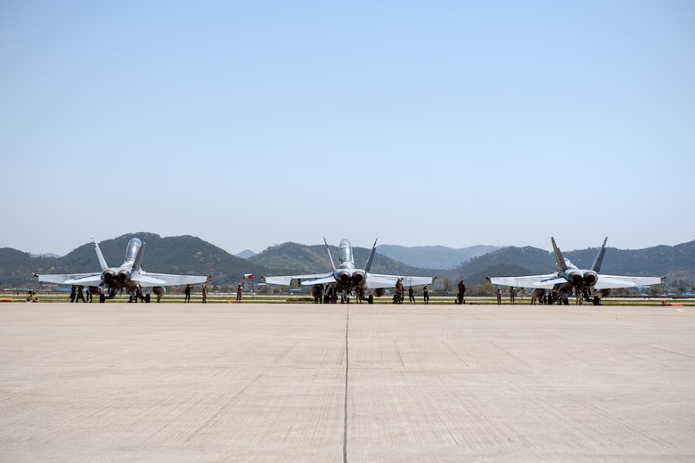 U.S. Marine Corps pilots from Marine Fighter Attack Squadron 225, currently deployed to Marine Corps Air Station Iwakuni, Japan, conduct pre-flight inspections of their F/A-18 Hornets during Exercise Max Thunder 15-1 at Gwangju Air Base, Republic of Korea, April 17, 2015. Max Thunder is a large-scale employment exercise designed to increase U.S. and ROK interoperability and ultimately enhance commitments to maintain peace in the region. (U.S. Air Force photo by Senior Airman Taylor Curry/Released) 