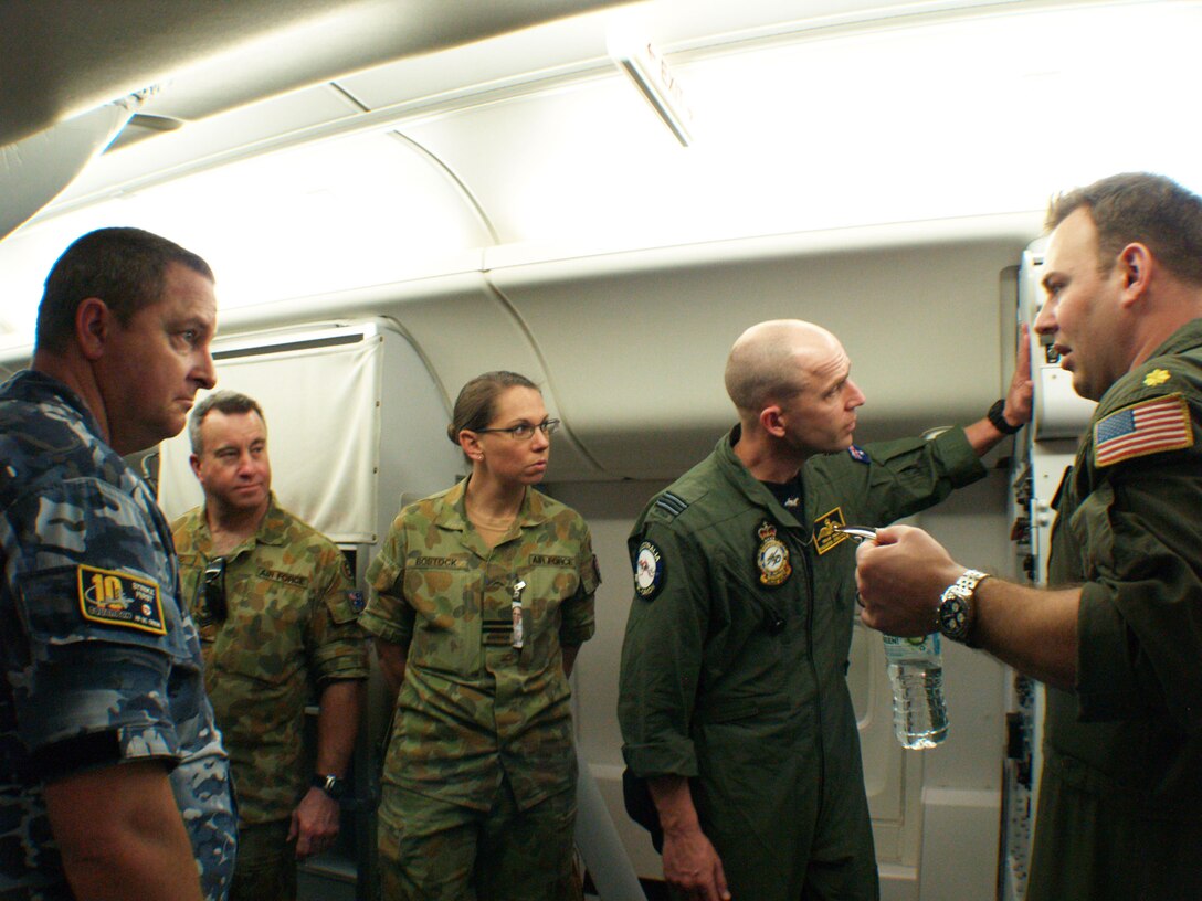 From the left, Royal Australian Navy Sgt. Mark Vearing, Royal Australian Air Force Fleet Sgt. Stuart Shepherd, Royal Australian Air Force Fleet Lt. Candice Bostock, and Royal Australian Air Force Squadron Leader Travis Hallen, are explained the streamlining of preflight procedures of a U.S. Navy P-8A Poseidon by U.S. Navy Lt. Cmdr. Matthew Olson, from Patrol Squadron 45, during Exercise Balikatan 2015 at Clark Air Base, Philippines, April 13. Balikatan is an annual Philippines-U.S. military bilateral training exercise and humanitarian assistance engagement in which the Australian Defence Force is contributing approximately 70 personnel and one AP-3C Orion patrol aircraft.