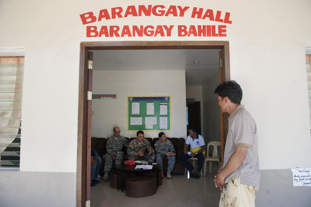 Arman Nunez, a Filipino exercise van driver, listens to U.S. Army Capt. Jesse Kittel, center left, Detachment 1230 officer in charge ,324th Psychological Operations (PSYOP) Company, Detachment 1230 and officer in charge, Staff Sgt. Chandelle Stone, center right, Detachment 1230 product development detachment noncommissioned officer in charge, 324th PSYOP Company, Detachment 1230 product development detachment noncommissioned officer in charge, and Spc. Edward Shipp, left, Detachment 1230 PSYOP specialist ,324th PSYOP Company, Detachment 1230 PSYOP specialist, as they talk to community leaders of a barangay, or village, about exercise Balikatan, April 23, in Bahile, Palawan, Philippines. Kittel, Stone, and Shipp are a part of the BK15 Military Information Support Operations and travel to barangays to inform community members about BK15 and strengthen relationships with the Philippines. This year marks the 31st iteration of the exercise, which is an annual Philippines-U.S. bilateral military training exercise and humanitarian civic assistance engagement. 