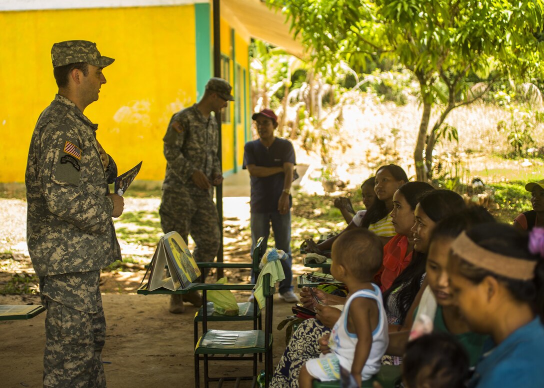 U.S. Army Capt. Jesse Kittel, psychological operations officer with the 324th Tactical Psychological Operations Company, 7th Psychological Operations Group, invites civilians  in Puerto Princesa, Philippines, to the dedication ceremony for a newly built classroom at the Sabang Elementary School to promote humanitarian civic assistance projects during exercise Balikatan 2015, April 24. The soldiers walked door to door to ensure that the local civilian populace was properly informed on the date and times for the ceremony. This year marks the 31st iteration of the exercise, which is an annual Philippine-U.S. military bilateral training exercise and humanitarian civic assistance engagement.