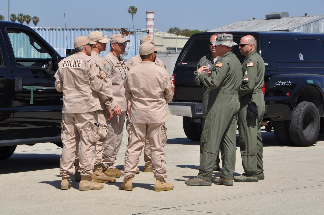 Federal law enforcement officers from the Department of Homeland Security’s HSI Division, Los Angeles, confer with senior officers from the 452nd Airlift Control Flight, March Air Reserve Base, California, before boarding a C-17 Globemaster III, April 17, 2015 at Joint Forces Training Center at Los Alamitos, California. DHS was one of the several affiliates who participated in the annual Patriot Hook Exercise sponsored by the Air Force Reserve Command, which integrates federal agencies with the military. (U.S. Air Force photo/Capt. Cris Medina)