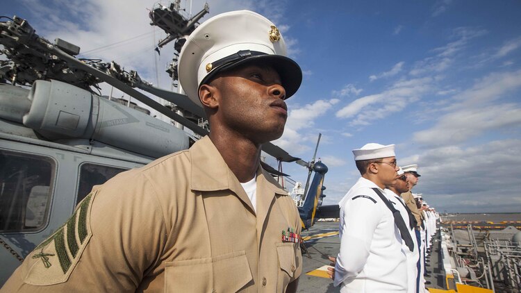 U.S. Marines and U.S. Navy Sailors with the 22nd Marine Expeditionary Unit and amphibious assault ship USS Wasp man the rails of the Wasp as it travels up the Mississippi River for Navy Week 2015 April 23, 2015. Marines and Sailors of the MEU, from Marine Corps Base Camp Lejeune, N.C., participated in Navy Week New Orleans April 23-29. The purpose of Navy Week was to showcase the strength and capabilities of the Navy and Marine Corps team through tours, static displays and community relations events, and to provide the public the opportunity to meet and interact with Marines and Sailors.