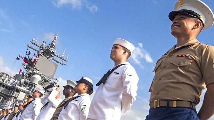 U.S. Marines and U.S. Navy Sailors with the 22nd Marine Expeditionary Unit and amphibious assault ship USS Wasp man the rails of the Wasp as it travels up the Mississippi River for Navy Week 2015 April 23, 2015. Marines and Sailors of the MEU, from Marine Corps Base Camp Lejeune, N.C., participated in Navy Week New Orleans April 23-29. The purpose of Navy Week was to showcase the strength and capabilities of the Navy and Marine Corps team through tours, static displays and community relations events, and to provide the public the opportunity to meet and interact with Marines and Sailors. 