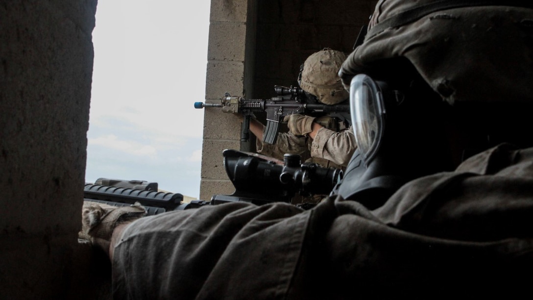 Marines with 1st Battalion, 7th Marine Regiment provide security in a simulated combat town during the culminating event of Division School’s Urban Leaders Course at Marine Corps Base Camp Pendleton, California, April 22, 2015. The three-week course is designed to prepare Marines to lead in an urban environment.
