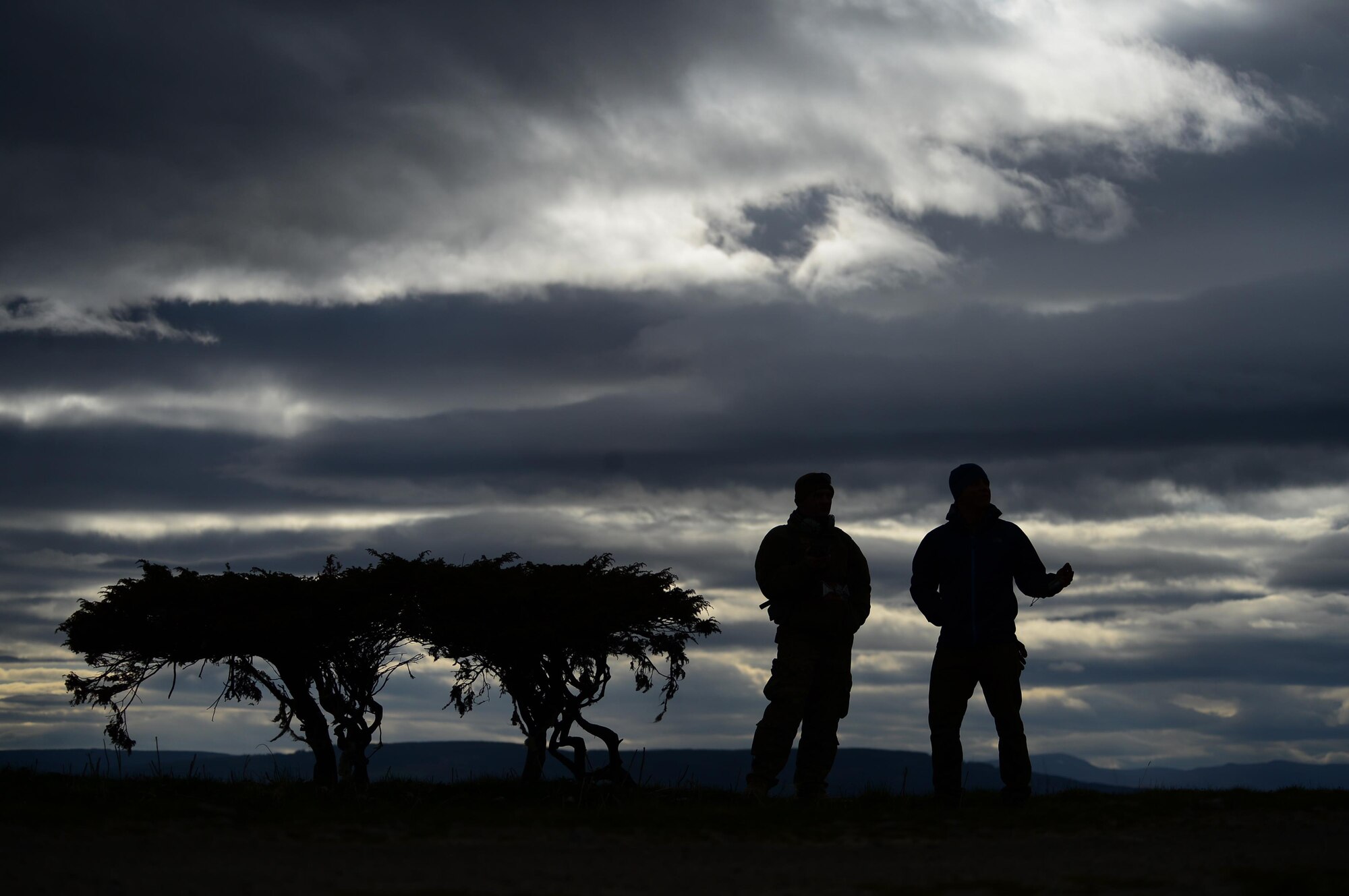 Staff Sgt. Rob Blume and Capt. Christopher Hewitt communicate during multinational exercise Joint Warrior 15-1 in Scotland, April 21, 2015. Blume is a 56th Rescue Squadron HH-60G Pave Hawk intelligence analyst and Hewitt is a 56th RQS flight surgeon. The exercise enhanced the 56th RQS's capability to support future real-world operations. (U.S. Air Force photo/Senior Airman Erin O'Shea)