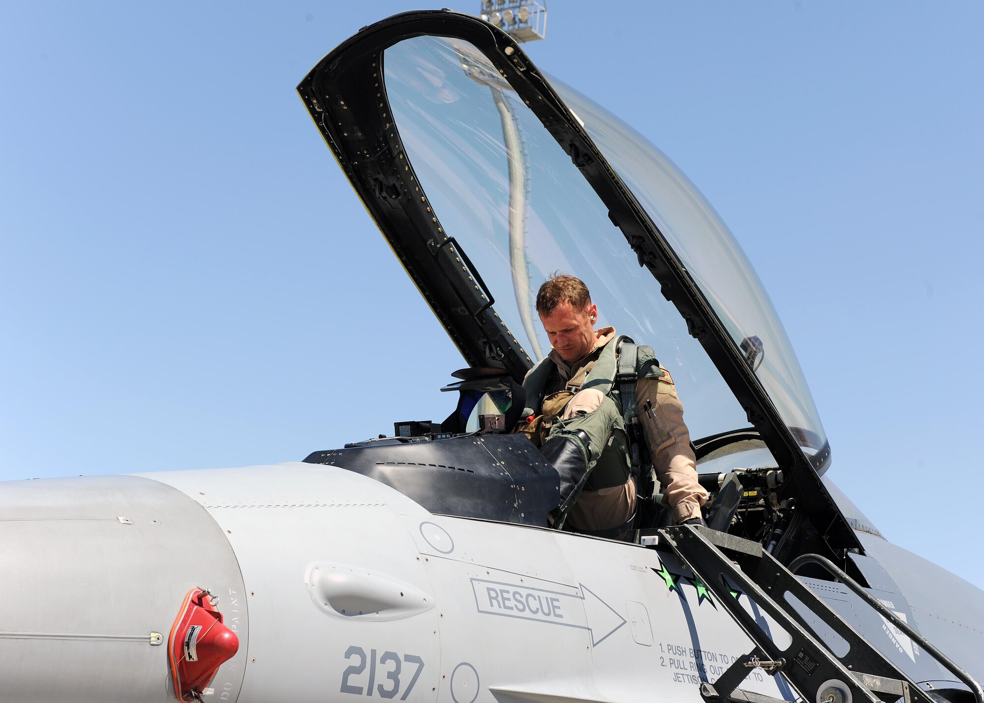 U.S. Air Force Maj. Matthew Eldredge, 555th Fighter Squadron pilot, prepares to disembark an F-16 Fighting Falcon “Triple Nickel” aircraft at Bagram Airfield, Afghanistan, April 27, 2015. Members of the Triple Nickel are deployed in support of Operations Freedom’s Sentinel and Resolute Support and are in theater to replace the 4th Fighter Squadron from Hill Air Force Base, Utah. (U.S. Air Force photo by Staff Sgt. Whitney Amstutz/released)