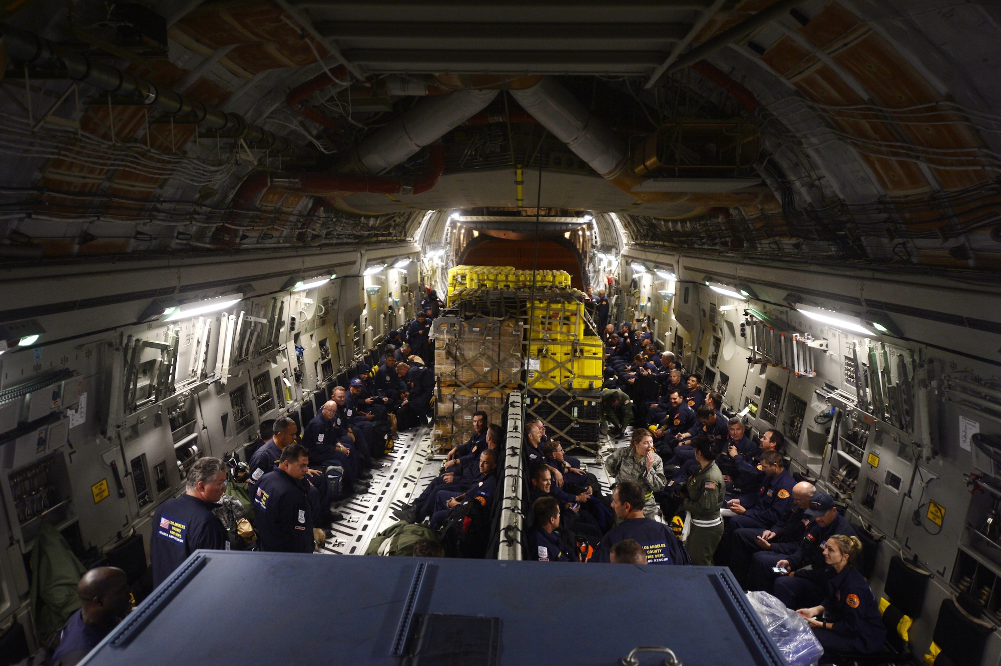 Service members load relief supplies for victims of the Nepal earthquake into a C-17 Globemaster III from Joint Base Charleston, S.C., at March Air Force Base, Calif., April 26, 2015. The U.S. Agency of International Development's relief cargo included eight pallets, 59 Los Angeles County Fire Department personnel and five search and rescue dogs. (U.S. Air Force photo/Airman 1st Class Taylor Queen)