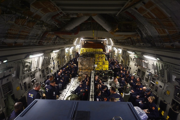 Service members load relief supplies for victims of the Nepal earthquake into a C-17 Globemaster III from Joint Base Charleston, S.C., at March Air Force Base, Calif., April 26, 2015. The U.S. Agency of International Development's relief cargo included eight pallets, 59 Los Angeles County Fire Department personnel and five search and rescue dogs. (U.S. Air Force photo/Airman 1st Class Taylor Queen)