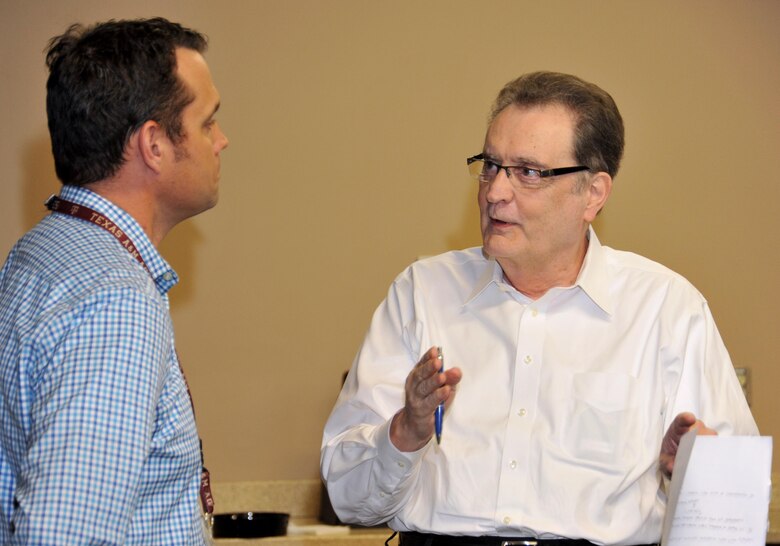 Chuck Beach, the Resource Efficiency Manager (REM) at Fort Knox, Kentucky, talks about third-party financing options with Rob Mackey, Huntsville Center's Energy Savings Performance Contracting (ESPC) program manager April 15 during the Army's first REM Workshop.